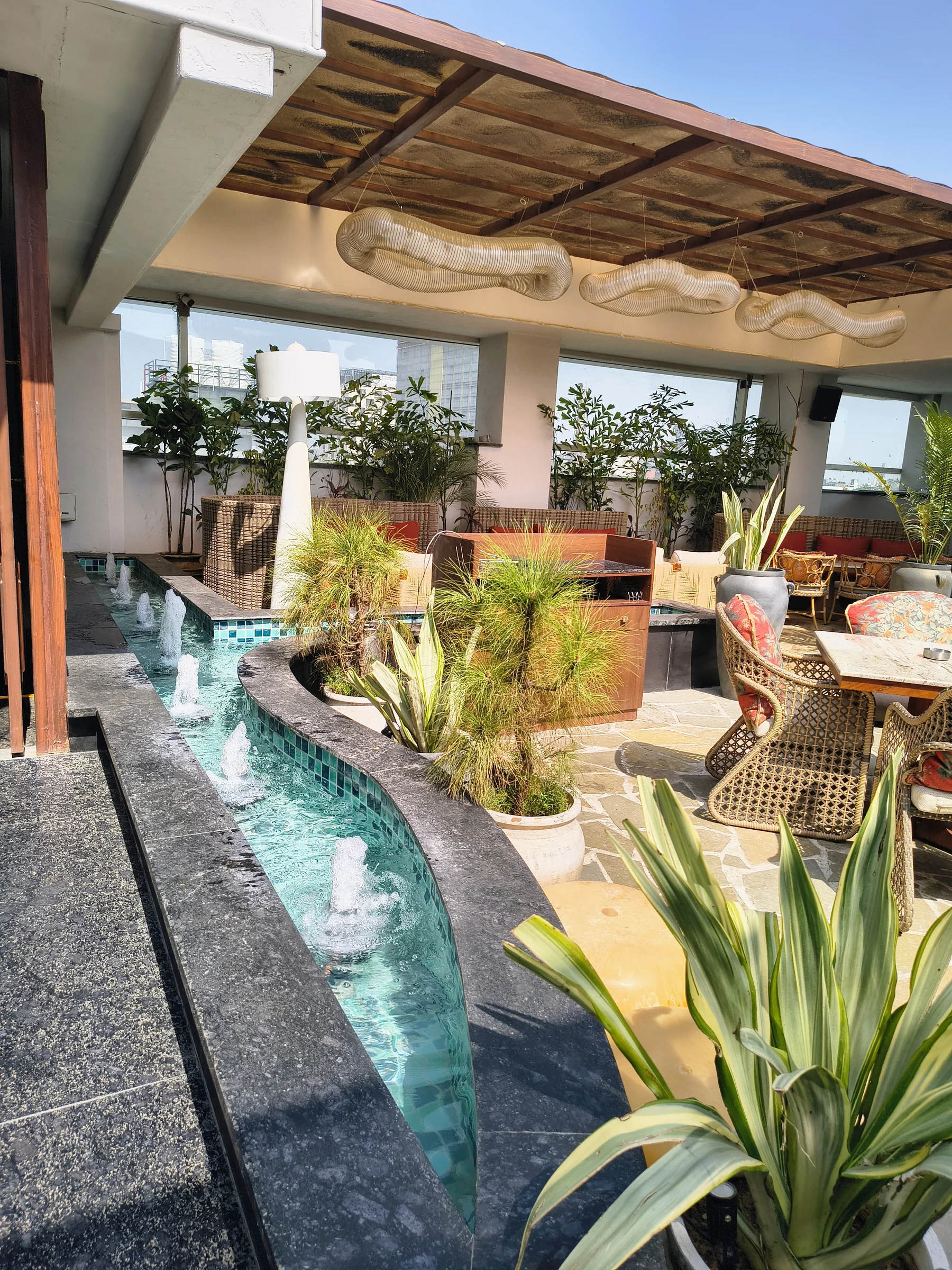 Planted outdoor seating at a premium restaurant in Delhi