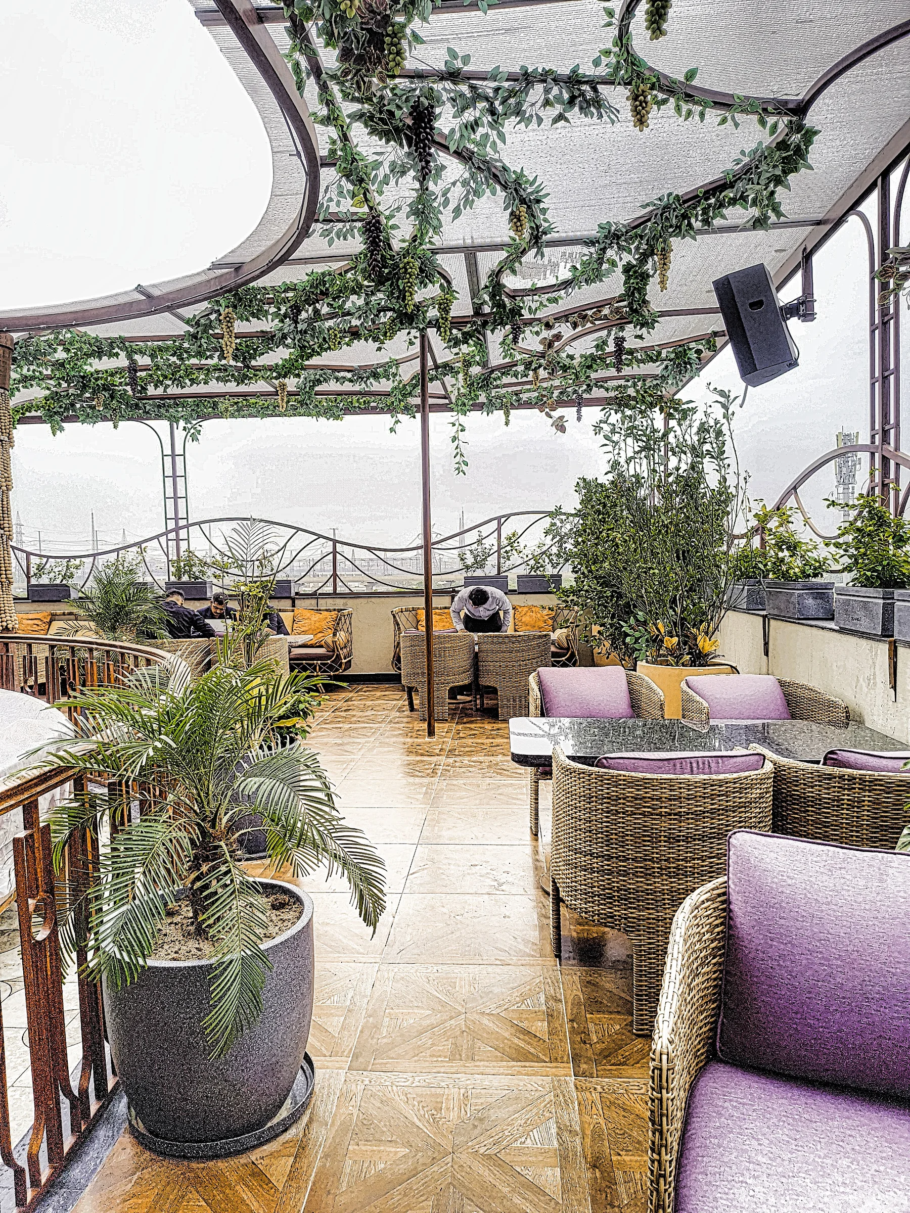 Landscaped terrace dining area at a luxury restaurant in Greater Noida