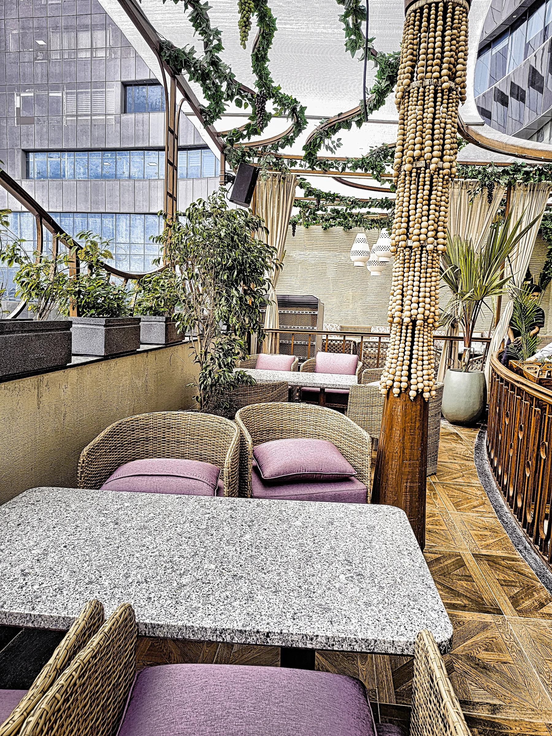 Planted terrace seating area at a luxury restaurant in Greater Noida